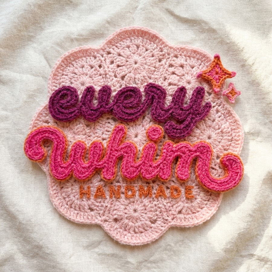 The Every Whim Handmade logo, hand-crocheted in plum and pink yarn on a pale pink granny square, with a small crocheted sparkle.